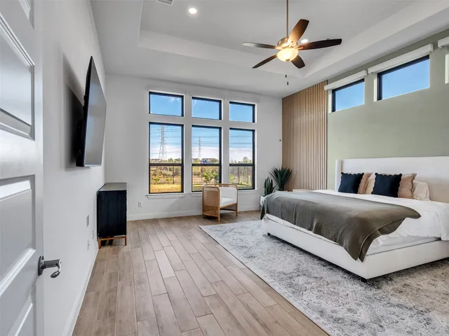 a bedroom with a large bed and a chandelier