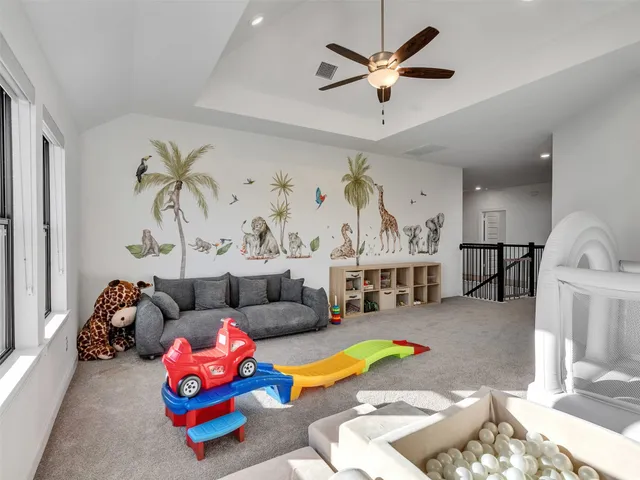 a bedroom with a large bed and a ceiling fan