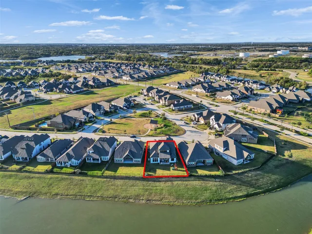 an aerial view of residential houses with outdoor space and swimming pool