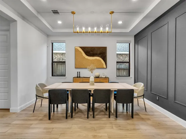 a view of a a dining room with furniture window and wooden floor