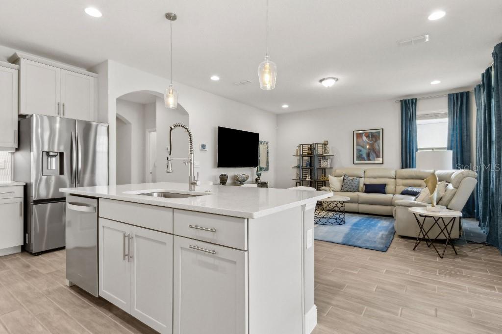 17936 Adrift Road Winter Garden, FL 34787 - Photo 11 of 44 a large white kitchen with a large window stainless steel appliances and furniture