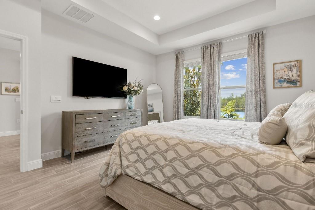 17936 Adrift Road Winter Garden, FL 34787 - Photo 21 of 44 a bedroom with a bed and a flat screen tv