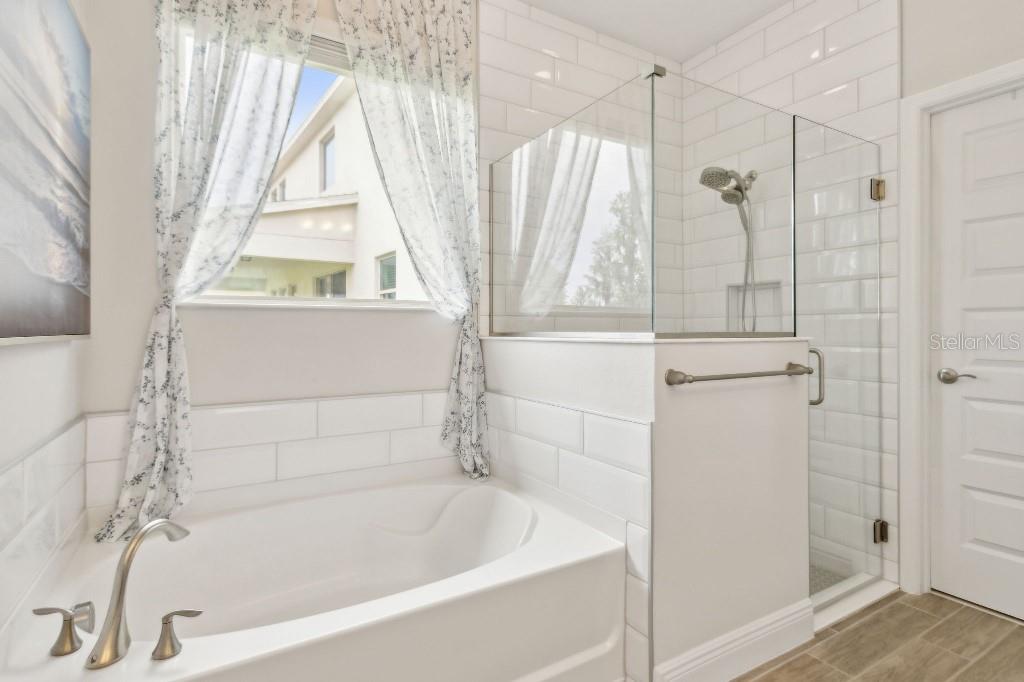 17936 Adrift Road Winter Garden, FL 34787 - Photo 24 of 44 a bathroom with a bathtub and a shower
