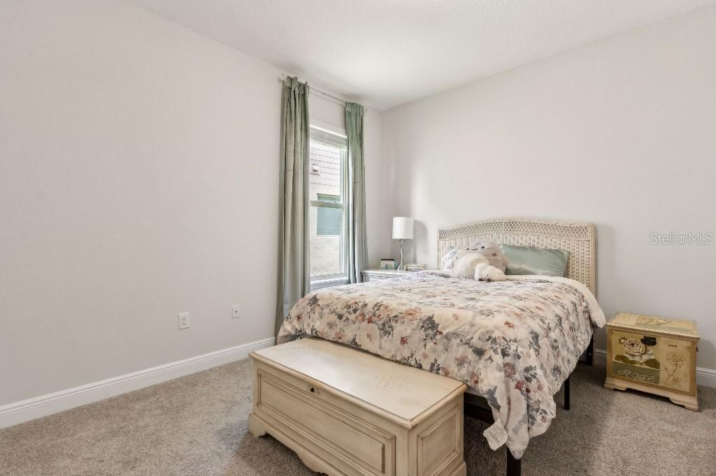 17936 Adrift Road Winter Garden, FL 34787 - Photo 25 of 44 a bedroom with a bed and a window