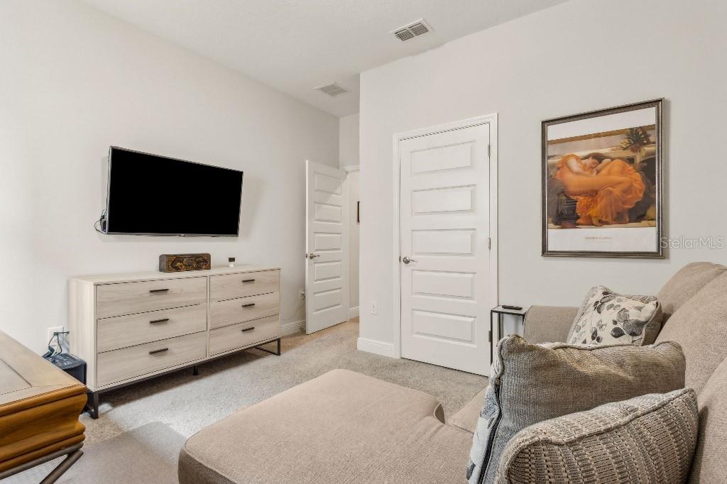 17936 Adrift Road Winter Garden, FL 34787 - Photo 27 of 44 a room with furniture and a flat screen tv