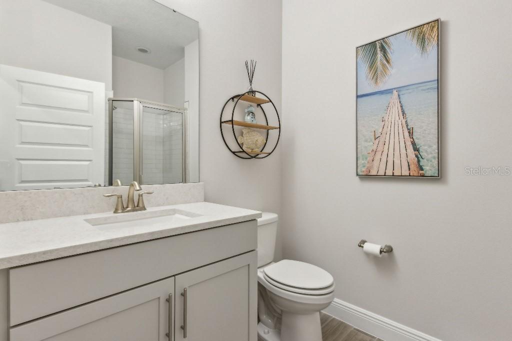 17936 Adrift Road Winter Garden, FL 34787 - Photo 29 of 44 a bathroom with a toilet a sink and mirror