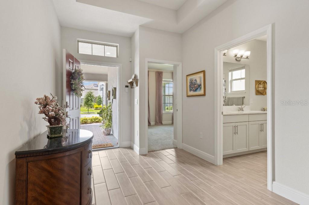 17936 Adrift Road Winter Garden, FL 34787 - Photo 7 of 44 a view of a hallway view with wooden floor and a living room