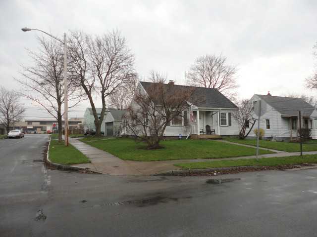 Exterior Front. Vinyl sided Cape Cod with 2 Car In