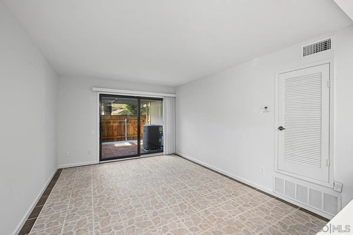 9787 Rimpark Way San Diego, CA 92124 - Photo 15 of 54 a view of an empty room with glass door
