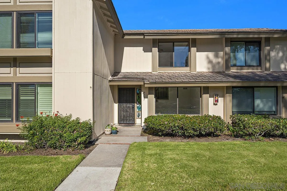9787 Rimpark Way San Diego, CA 92124 - Photo 2 of 54 a front view of a house with a yard