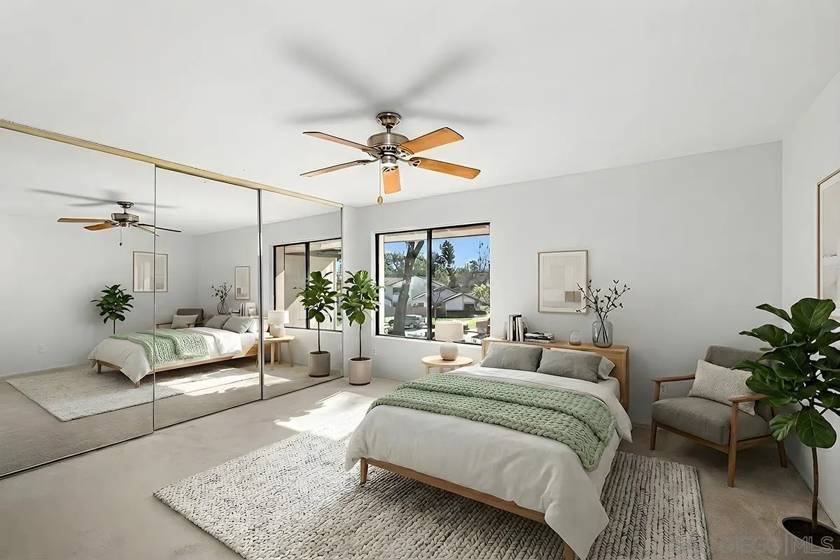 9787 Rimpark Way San Diego, CA 92124 - Photo 21 of 54 a bedroom with a large bed and a chandelier