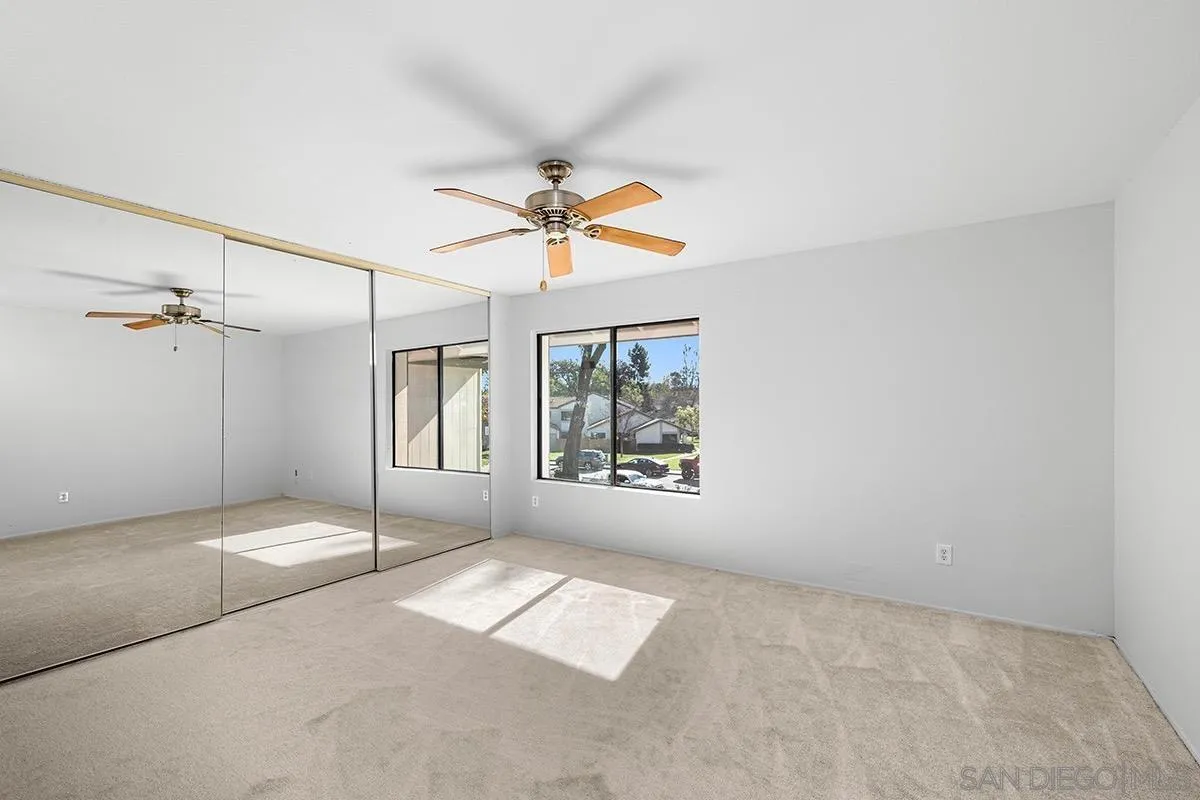 9787 Rimpark Way San Diego, CA 92124 - Photo 22 of 54 an empty room with windows and fan