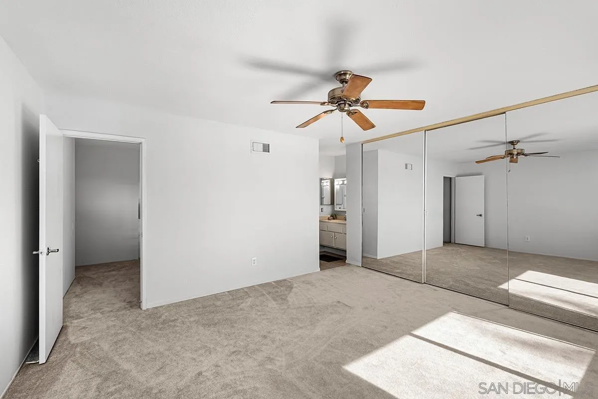 9787 Rimpark Way San Diego, CA 92124 - Photo 23 of 54 a view of a big room with a ceiling fan and a chandelier fan