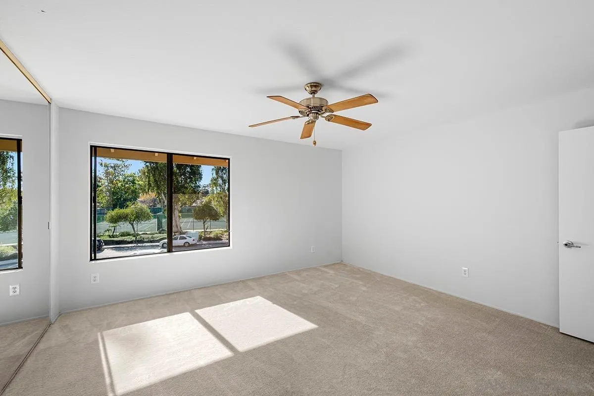 9787 Rimpark Way San Diego, CA 92124 - Photo 24 of 54 an empty room with windows and fan