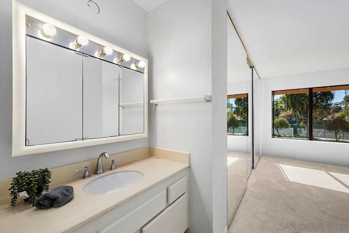 9787 Rimpark Way San Diego, CA 92124 - Photo 25 of 54 a bathroom with a sink and a mirror