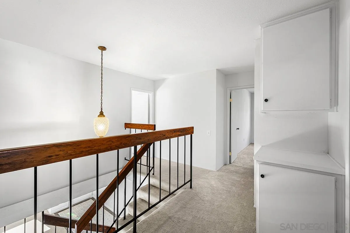 9787 Rimpark Way San Diego, CA 92124 - Photo 26 of 54 a view of a hallway with windows
