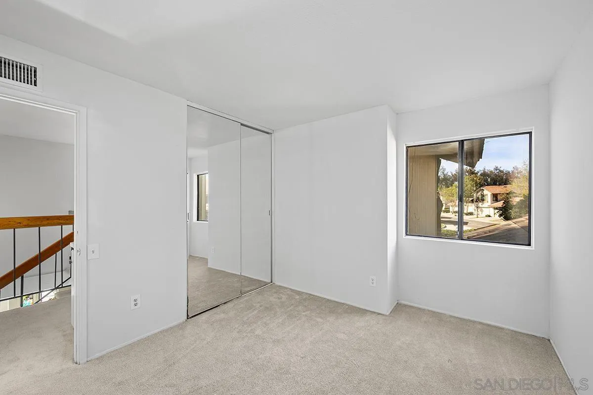 9787 Rimpark Way San Diego, CA 92124 - Photo 34 of 54 an empty room with windows and closet