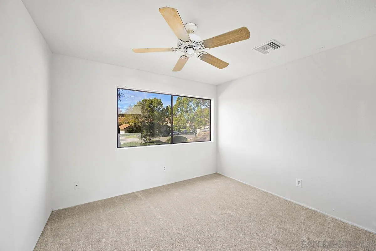 9787 Rimpark Way San Diego, CA 92124 - Photo 36 of 54 an empty room with windows and fan