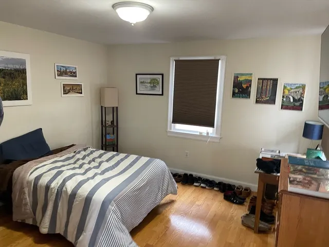a bedroom with a bed and a desk
