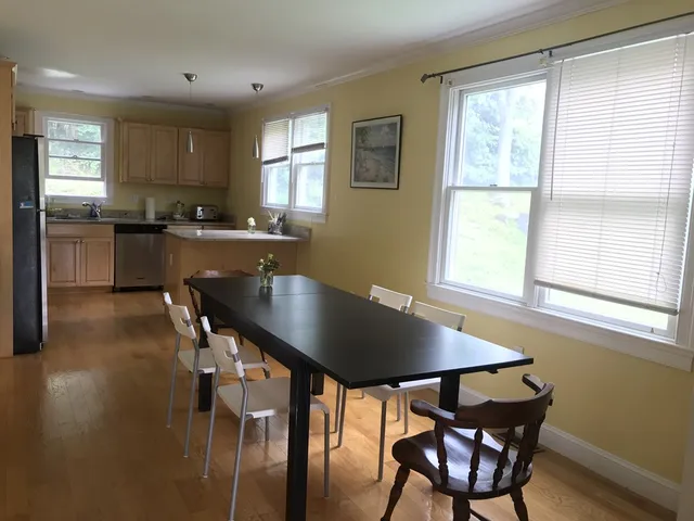 a kitchen with a table chairs sink and cabinets