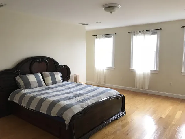 a bedroom with a bed and window