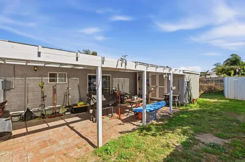 a view of a house with backyard porch and sitting area