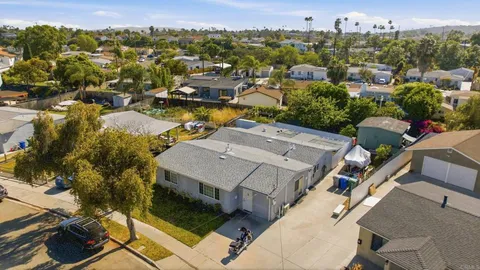 an aerial view of a houses with a swimming pool