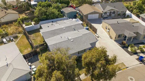 an aerial view of a house with a yard and garden