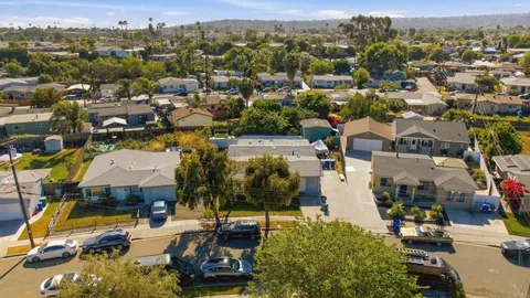 an aerial view of a houses with a lake view