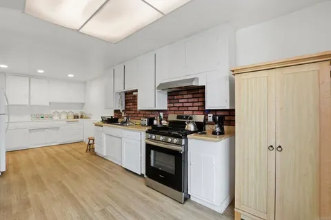 a kitchen with a stove a sink and a refrigerator