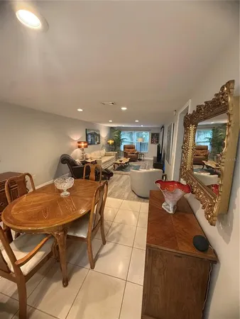 a living room with furniture a flat screen tv and a table