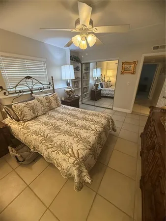 a bedroom with a bed and a mirror