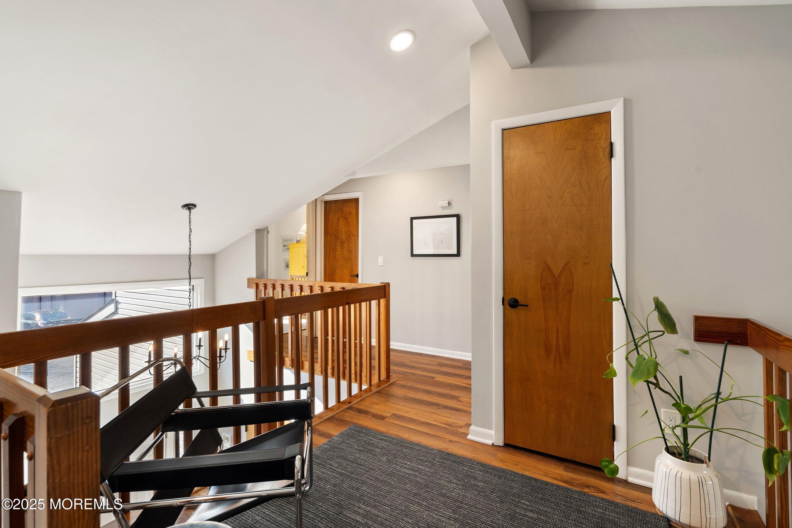 51 White Swan Way Brick, NJ 08723 - Photo 13 of 21 a view of a hallway with wooden floor and stairs