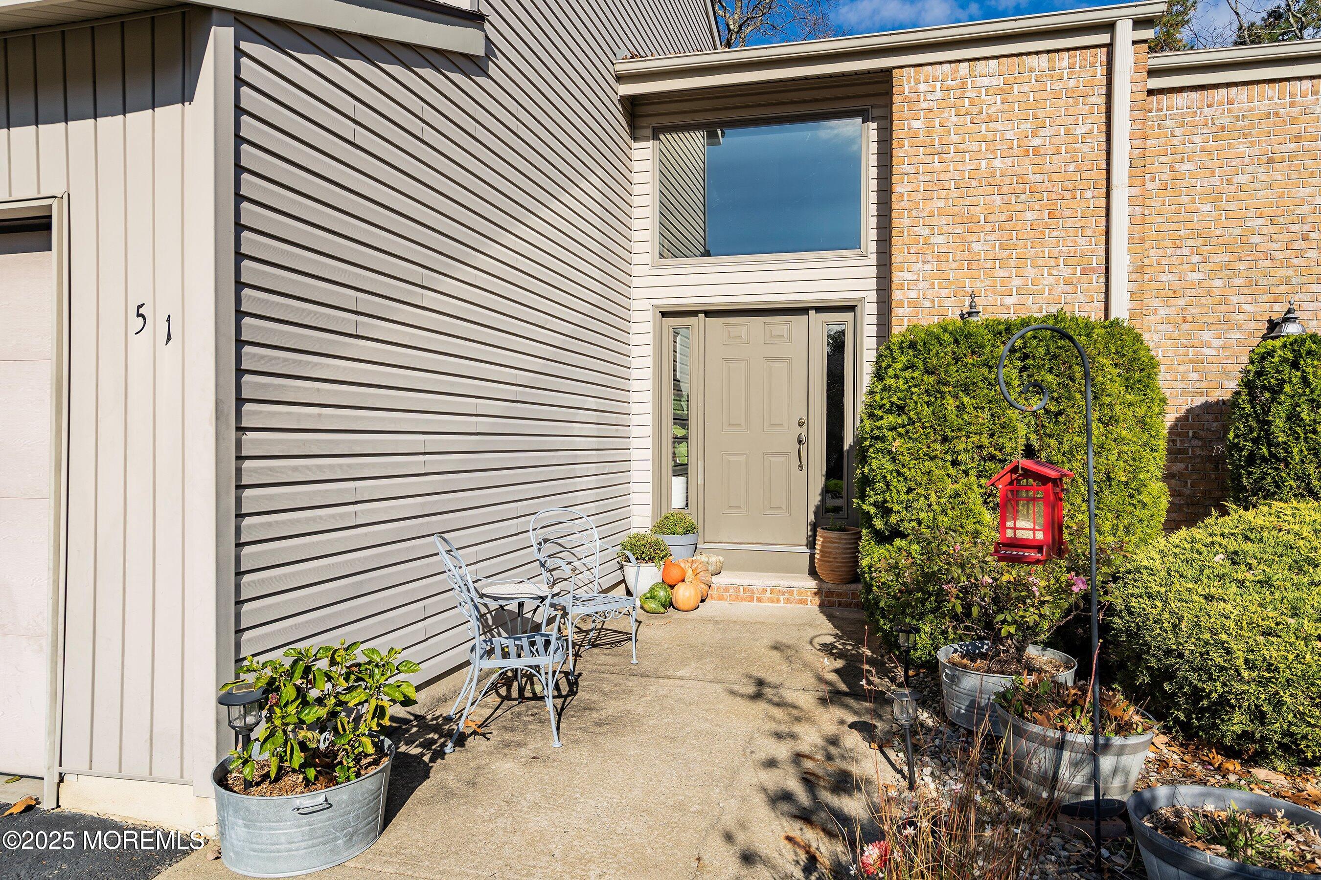 51 White Swan Way Brick, NJ 08723 - Photo 2 of 21 a potted plant sitting in front of a house