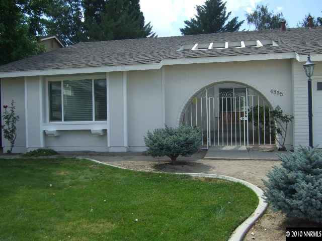 4865 Warren Way Reno, NV 89509 - Photo 2 of 9 a front view of a house with garden