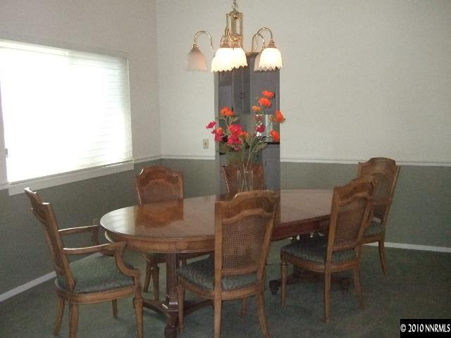 4865 Warren Way Reno, NV 89509 - Photo 3 of 9 a view of a dining room with furniture and wooden floor