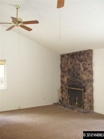 4865 Warren Way Reno, NV 89509 - Photo 5 of 9 a view of a livingroom with a fireplace and a window