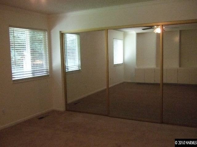 4865 Warren Way Reno, NV 89509 - Photo 7 of 9 an empty room with windows and closet