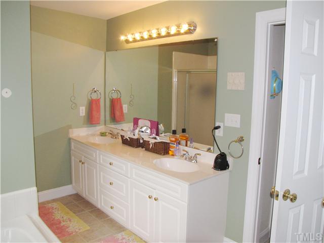 1512 Patterson Grove Road Apex, NC 27502 - Photo 13 of 25 Double Vanities, Whirlpool Tub, Seperate Tile Shower & Tile Flooring accent the Master Bath.