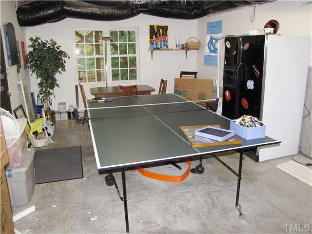 1512 Patterson Grove Road Apex, NC 27502 - Photo 21 of 25 This is one of 2 storage rooms in the basement. It is being used for table tennis. There is also a 3rd storage room in the finished attic! This space could also be used as a workshop.
