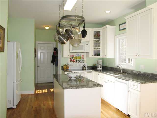 1512 Patterson Grove Road Apex, NC 27502 - Photo 7 of 25 The Island Kitchen boasts hardwood flooring, granite counter tops, plenty of cabinets and a Pantry.