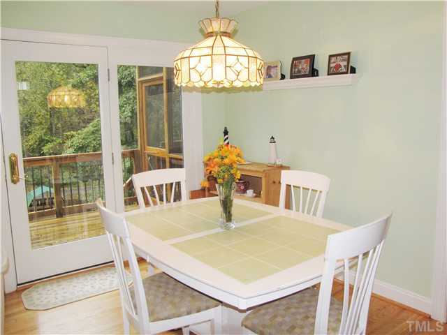 1512 Patterson Grove Road Apex, NC 27502 - Photo 9 of 25 The bright Breakfast Nook overlooks the deck and fenced back yard which backs to the greenway!