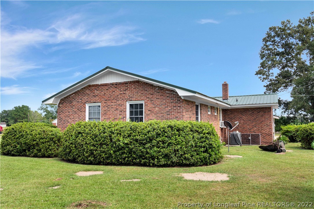 7400 East Raynham Road Fairmont, NC 28340 - Photo 19 of 21 a front view of a house with a yard