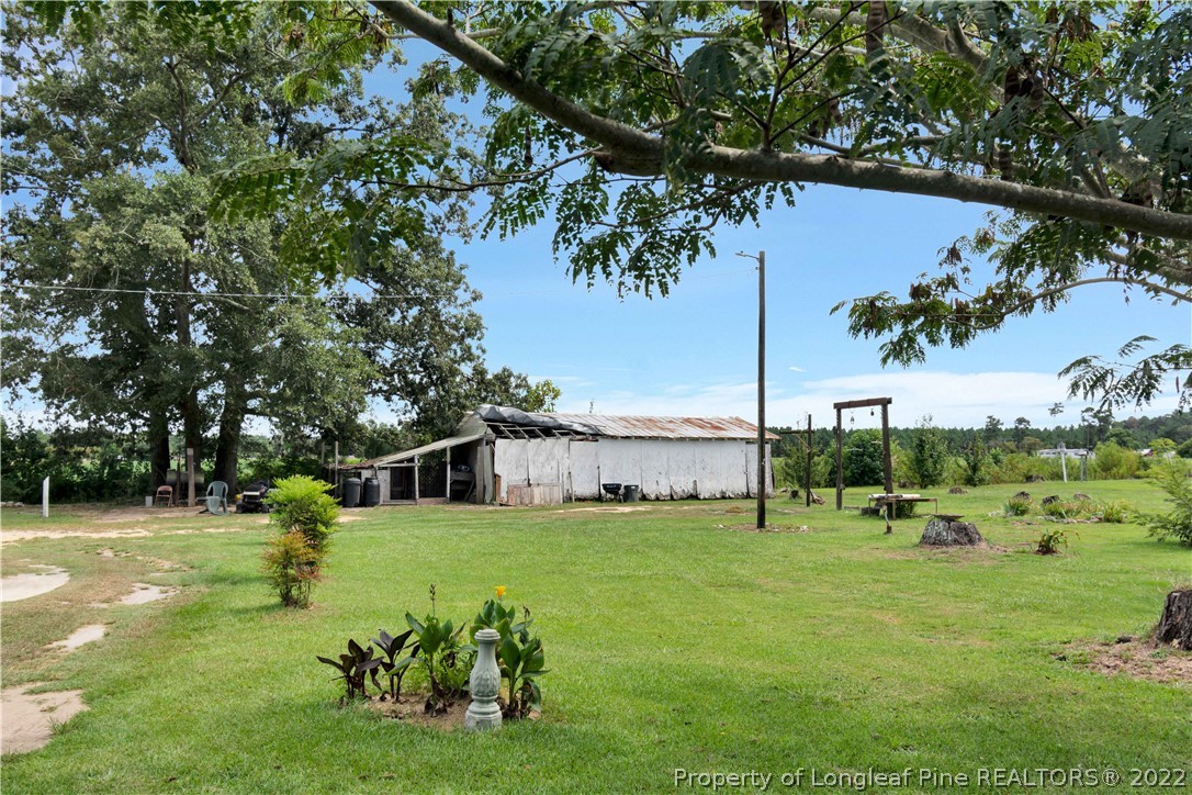 7400 East Raynham Road Fairmont, NC 28340 - Photo 21 of 21 a view of a house with a yard