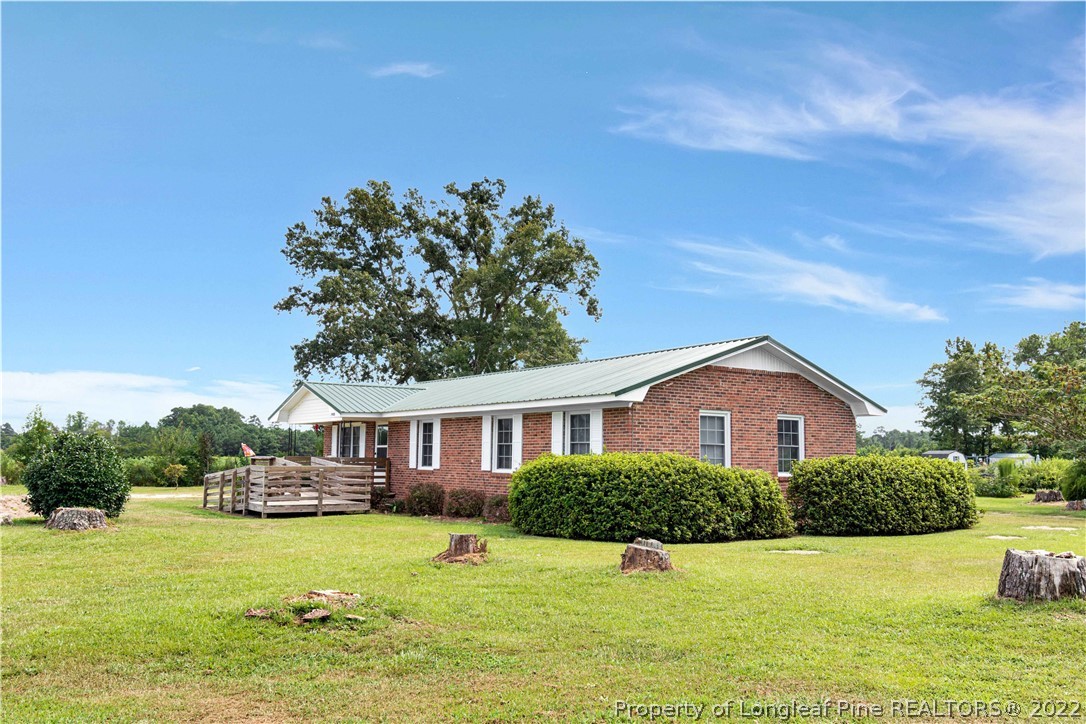 7400 East Raynham Road Fairmont, NC 28340 - Photo 3 of 21 a front view of a house with a yard