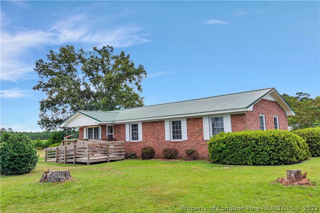 7400 East Raynham Road Fairmont, NC 28340 - Photo 4 of 21 a front view of a house with a garden