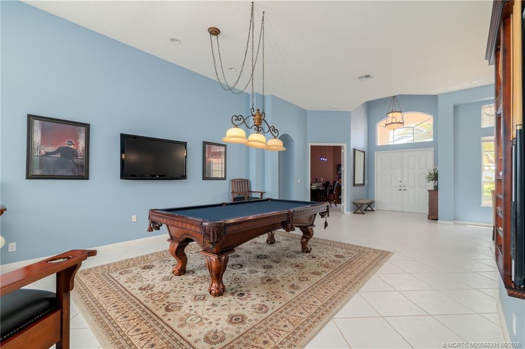 2216 Southeast Stonehaven Road Port St. Lucie, FL 34952 - Photo 8 of 67 a living room with furniture and a flat screen tv