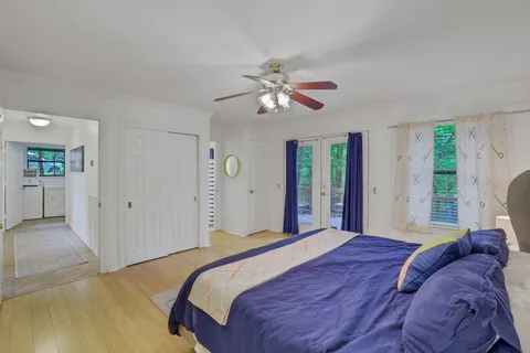 a bedroom with a large bed and a chandelier