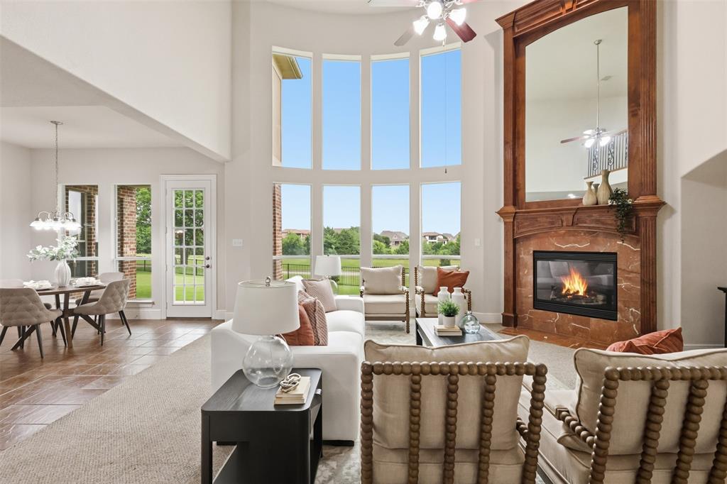 2841 Meadow Ridge Drive Prosper, TX 75078 - Photo 8 of 40 a living room with furniture fireplace and a large window