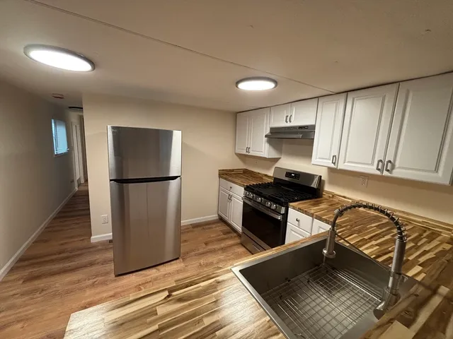 a kitchen with wooden cabinets and a stove top oven